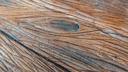Close-up of a faux wooden surface with visible grain and texture made on leather