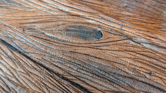 Close-up of a faux wooden surface with visible grain and texture made on leather